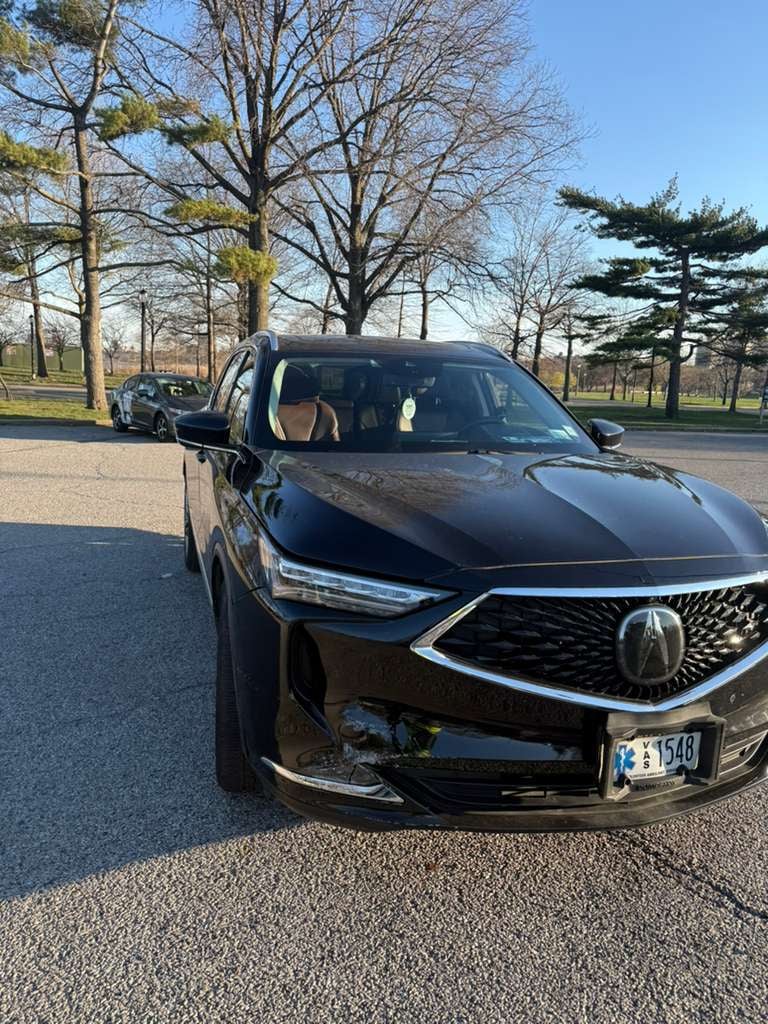 Acura MDX with front-end collision damage delivered to Flushing Meadows-Corona Park in Queens by JG Towing.
